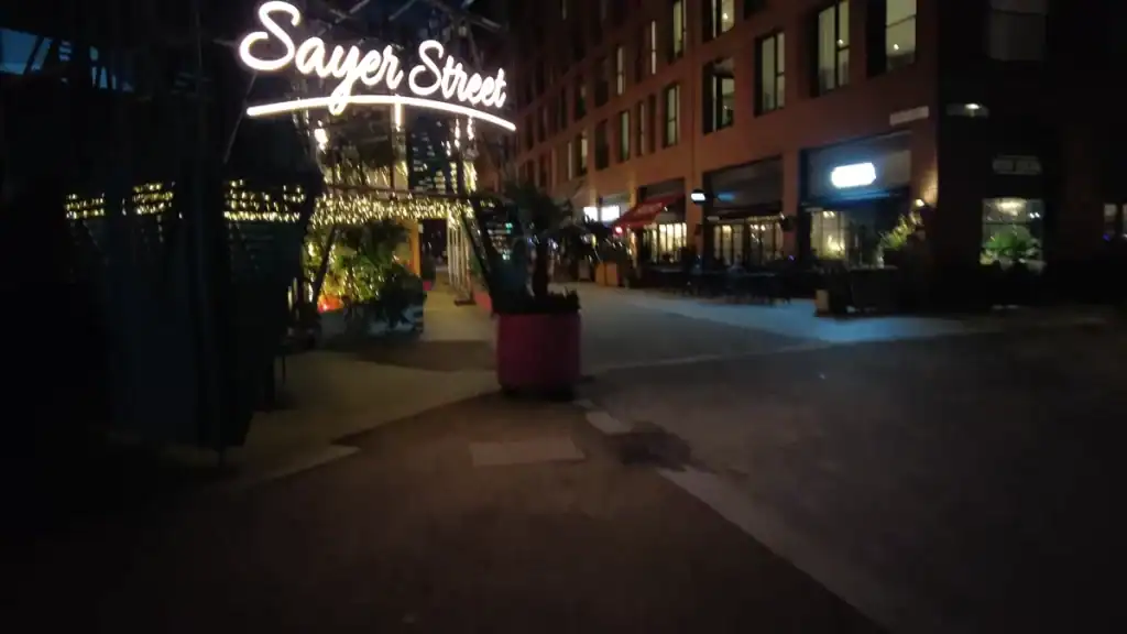 Night on Sayer Street with lighting and people