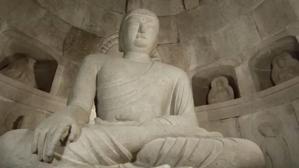 Andong cultural experience stone Buddha statue at Seokguram Grotto in meditation pose with carved granite ceiling and relief sculptures