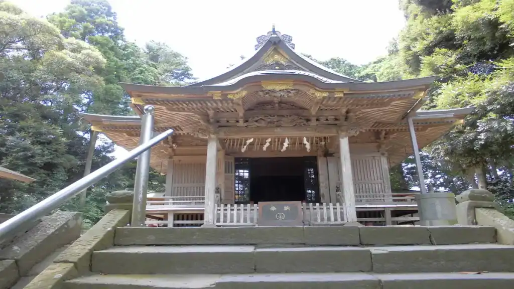 Suwa Shrine wooden main hall with curved roof and ornate carvings surrounded by forest in Sawara