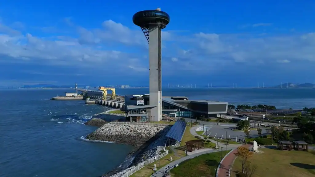 T-Light observation tower at coastal park in Ansan with modern buildings, pier, and panoramic ocean views