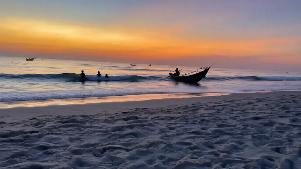 Traditional fishing boats at sunrise on Tam Thanh Beach when comparing Tam Ky vs Hoi An coastlines