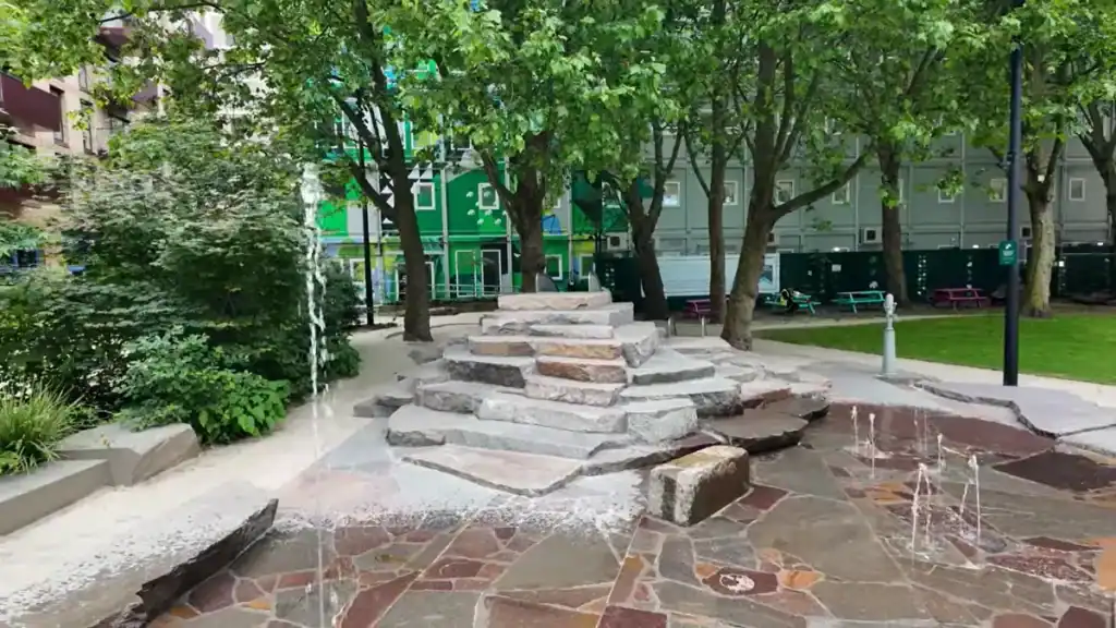 Enjoying the interactive water park with rock features