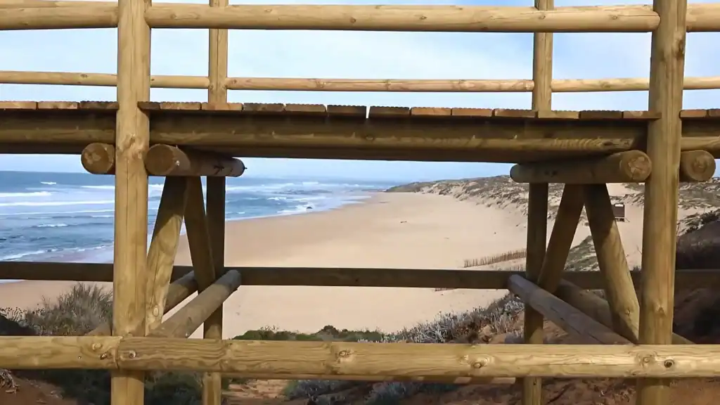 Wooden viewing platform overlooking wild sandy beach at Milfontes showing how many days to visit