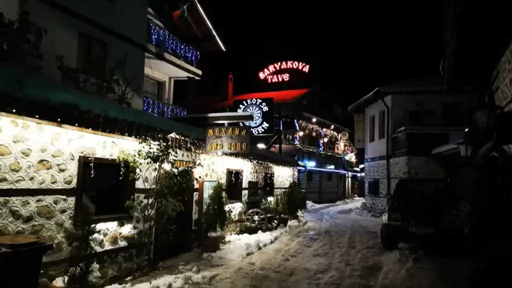 Bansko summer vs winter illuminated bars and restaurants on snowy street