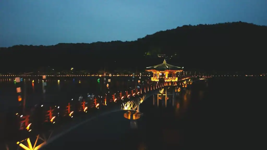 Things to do in Andong illuminated Woryeonggyo Bridge at night with traditional Korean pavilion and colorful lights reflecting on water
