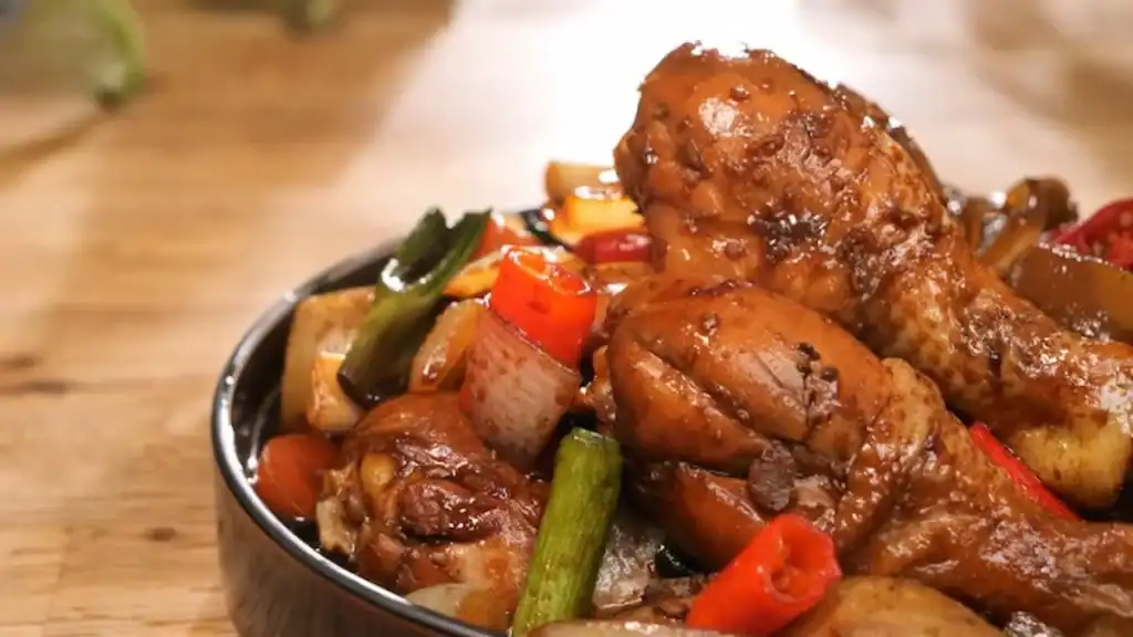 Andong Jjimdak traditional Korean braised chicken dish with potatoes green onions red peppers mushrooms in glossy soy sauce glaze