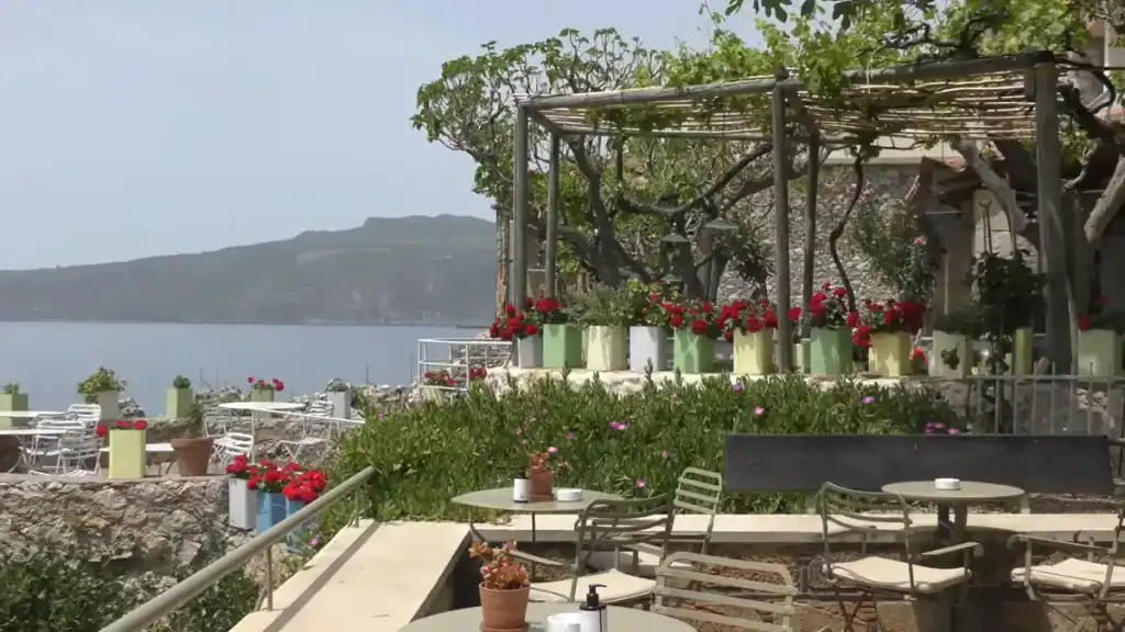 Where to Stay in Mani coastal cafe with flowering garden.
