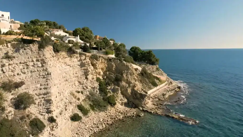 Moraira beaches feature Cala Cap Blanc with dramatic limestone cliffs and coastline.