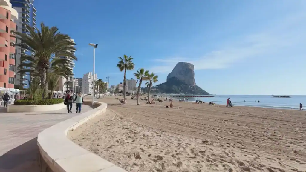 Moraira vs Calpe beach view showing Arenal-Bol promenade and iconic rock.