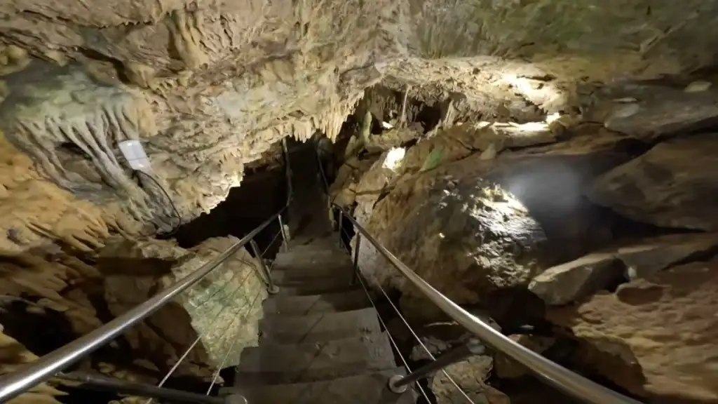 Stone staircase descending into the illuminated Diros Caves on the Mani Peninsula