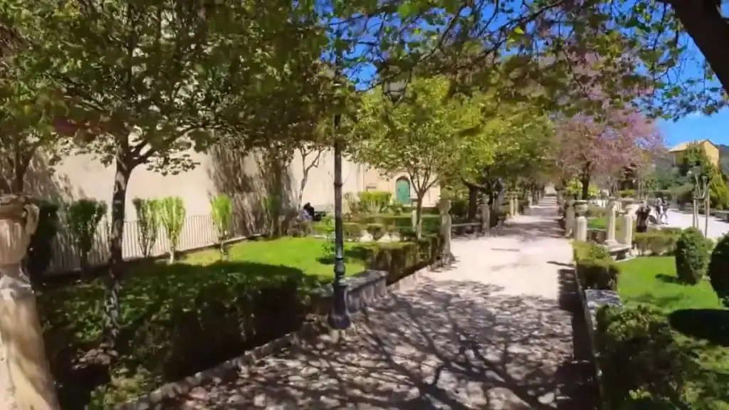 Tree-lined path through Giardino Ibleo, stone balustrades and clipped hedges along one side, a useful stop in any Ragusa guide covering the quieter eastern end of Ibla.