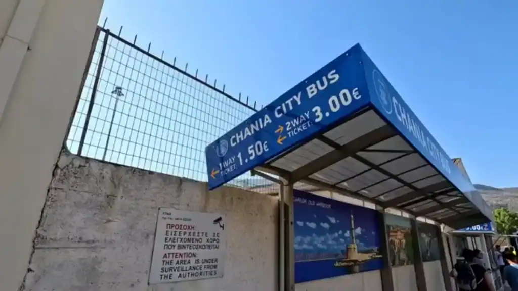 Chania City Bus stop at Souda port showing ticket prices, the Souda Bay to Chania fare listed as 1.50 euros one way