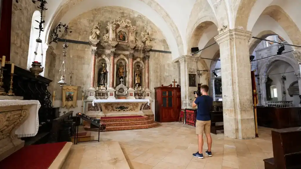 Visitor photographs the side altar inside St Mark's Cathedral