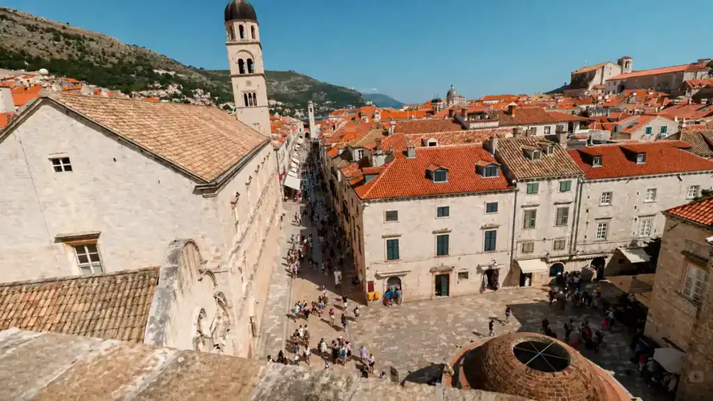 Stradun promenade lined with orange-roofed buildings and crowds in Dubrovnik old town