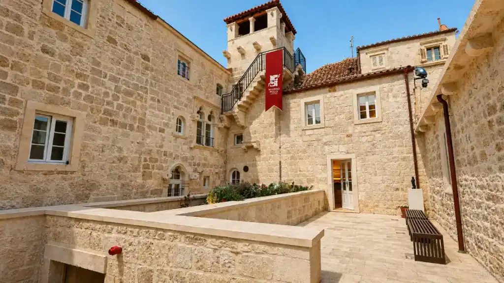 Stone courtyard and tower at Marco Polo House before you explore outside Korčula town
