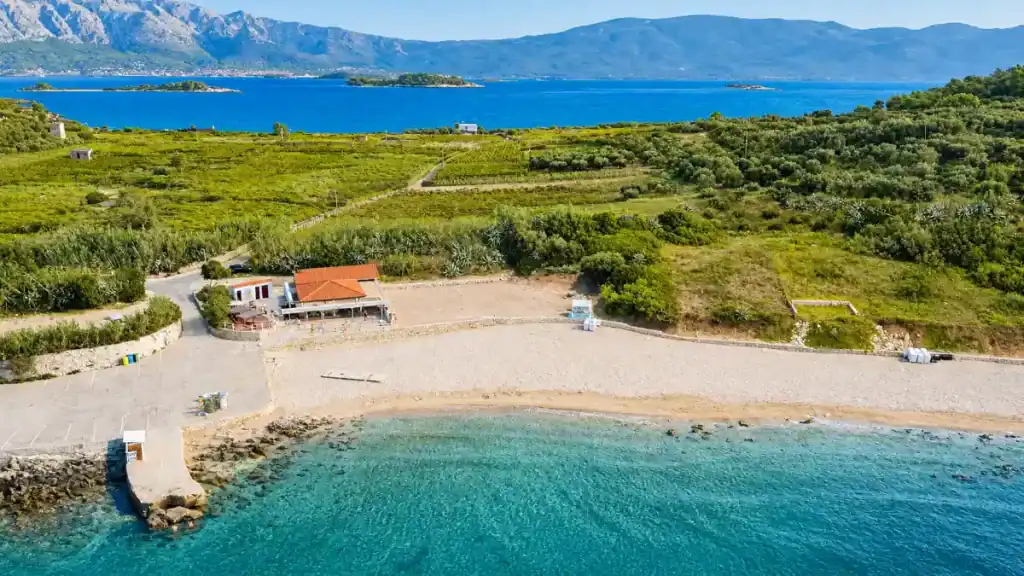 Aerial view of Vela Pržina sandy beach in Lumbarda, an easy day trip to explore from Korčula Town