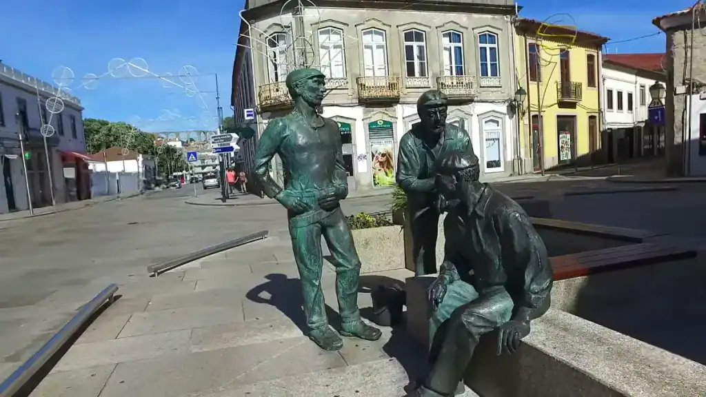 Bronze fishermen sculptures on a quiet town square street in Vila do Conde in winter