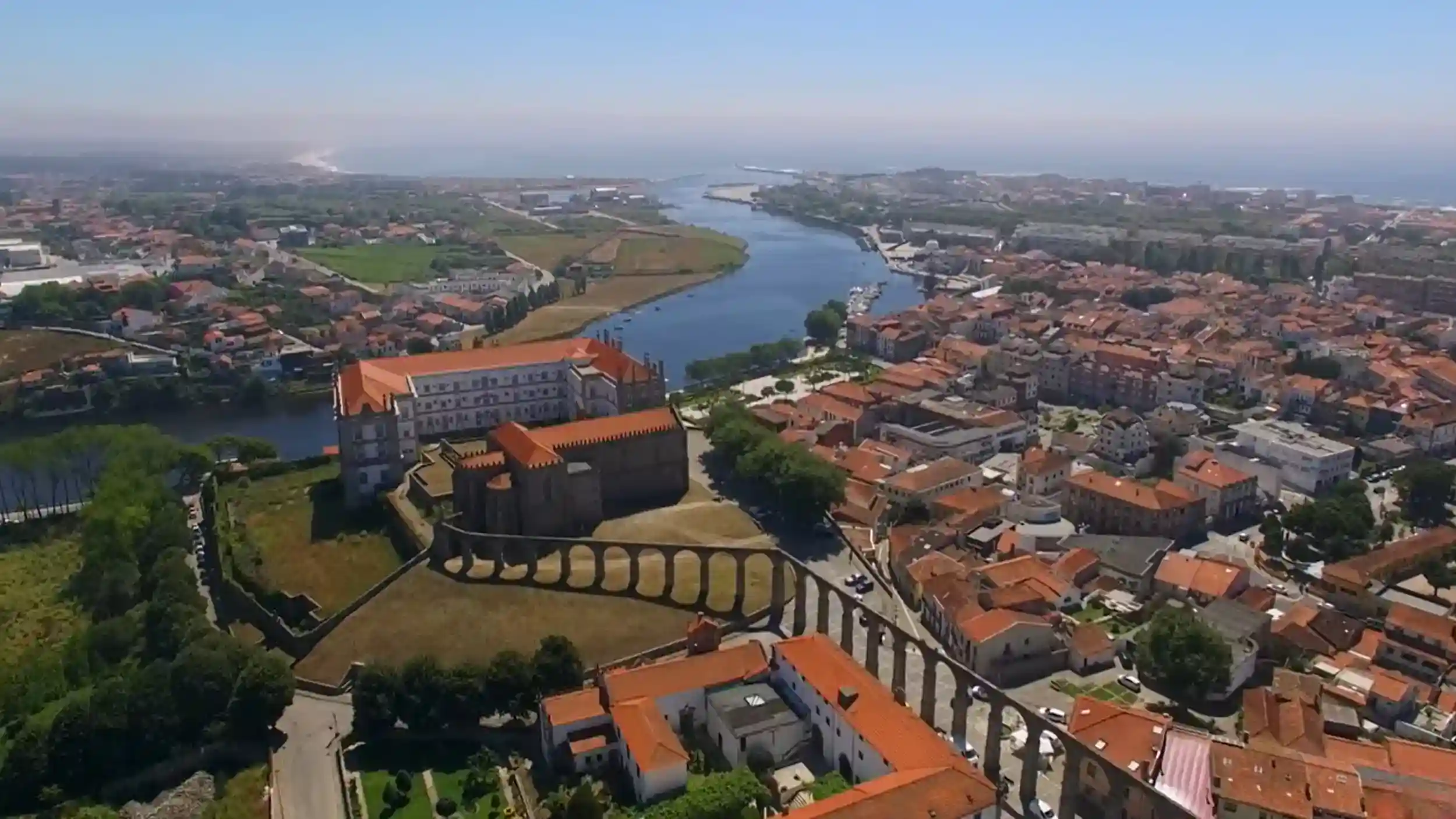 Aerial view of Vila do Conde monastery complex beside the Ave River and its aqueduct