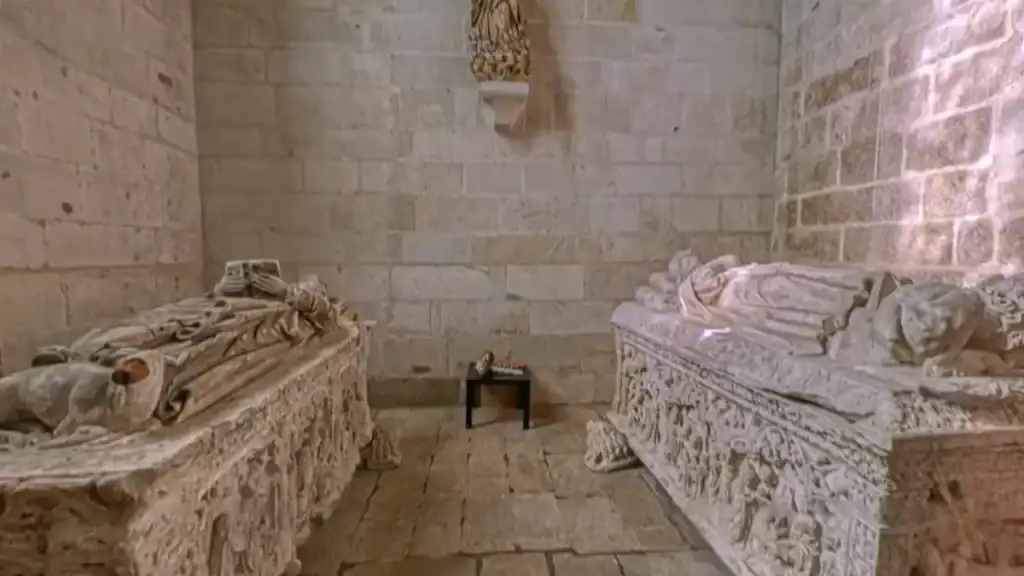 Two ornately carved medieval stone tombs inside the Vila do Conde monastery church