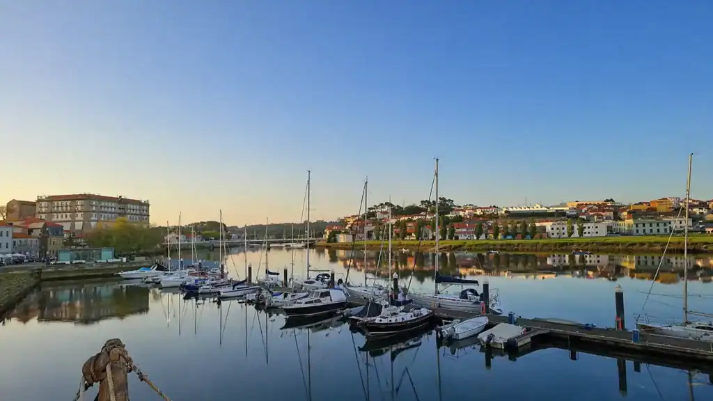 Sailboats moored on the River Ave at golden hour with Vila do Conde things to do along the waterfront