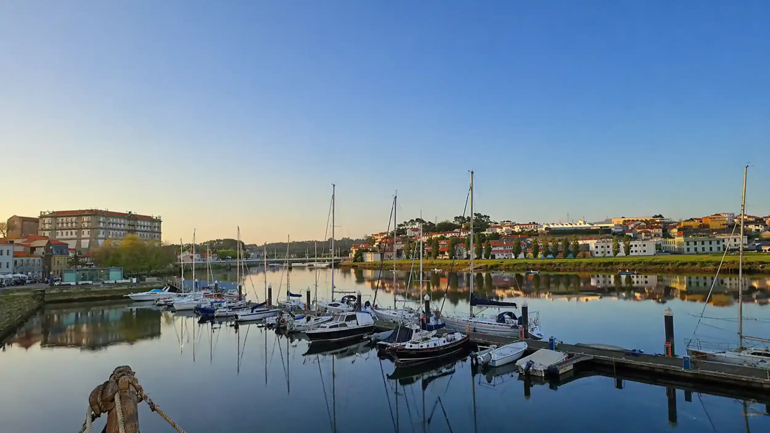 Sailboats moored on the River Ave at golden hour with Vila do Conde things to do along the waterfront