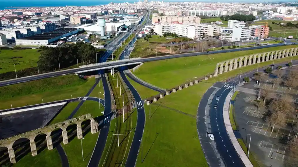 Historic stone aqueduct arches running alongside modern roads in Vila do Conde