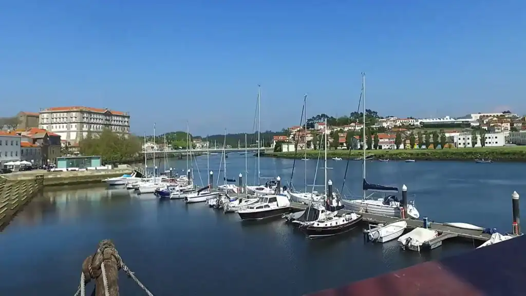 Sailboats moored on the River Ave with Vila do Conde worth visiting on the far bank