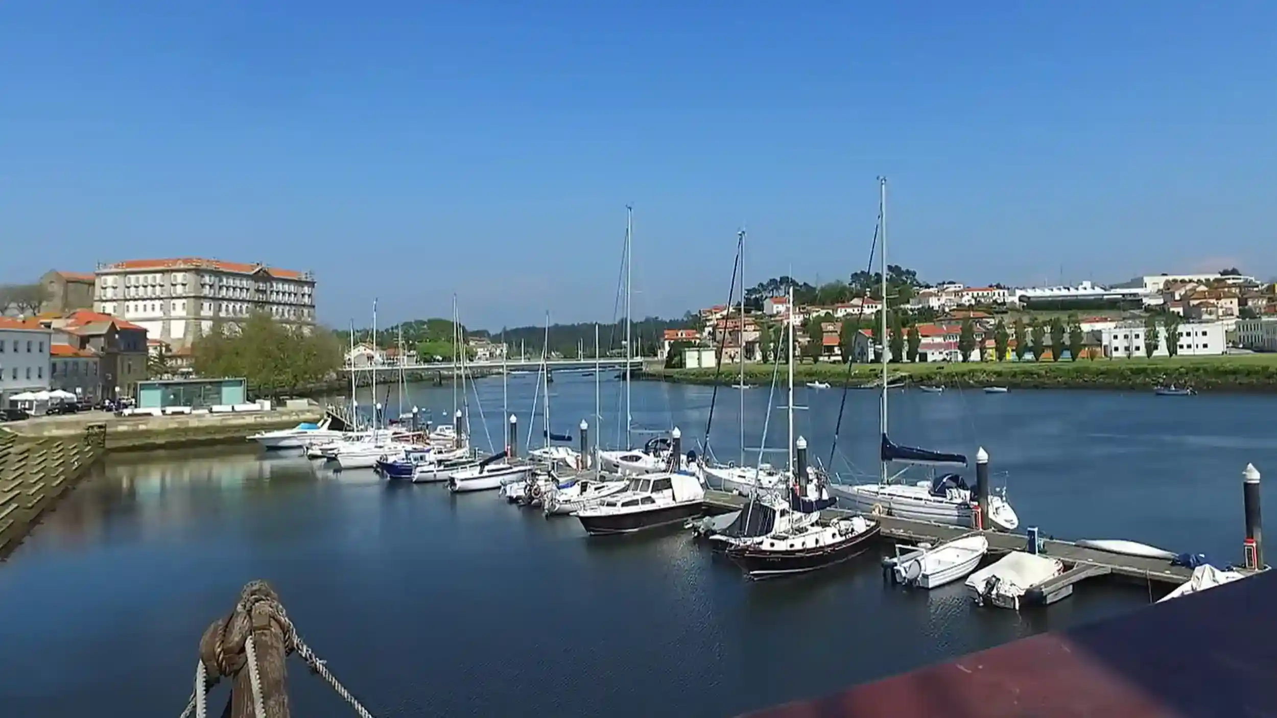 Sailboats moored on the River Ave with Vila do Conde worth visiting on the far bank