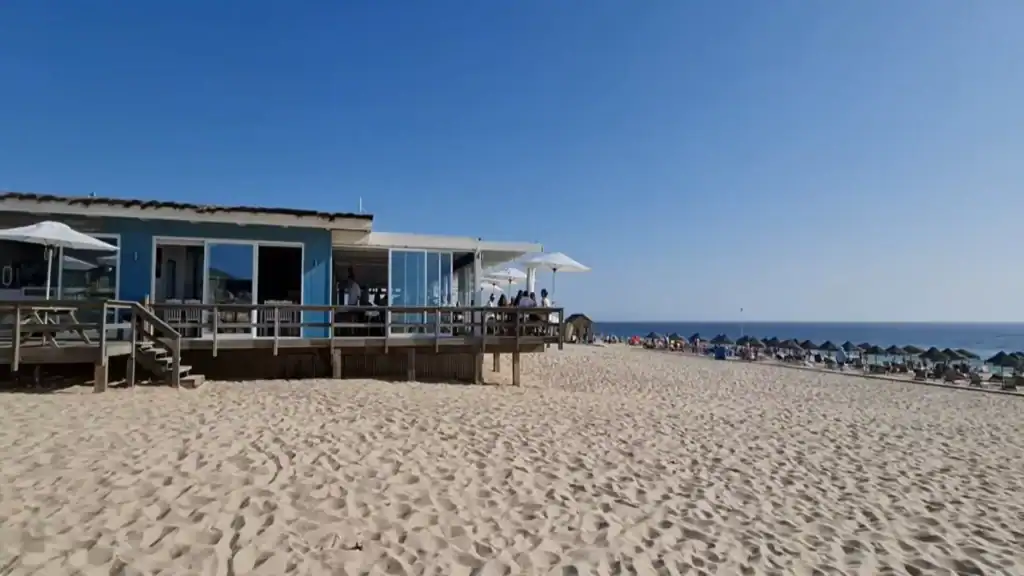 Blue beachfront restaurant with wooden deck on the Comporta Coast