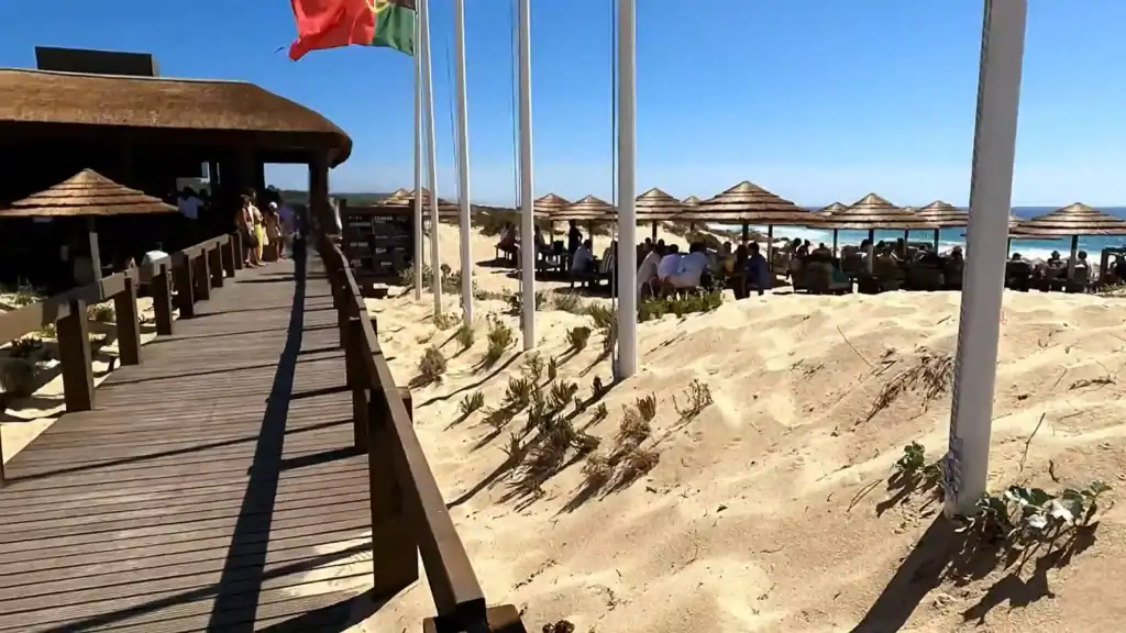 Thatched beach bar and wooden boardwalk at Praia do Pêgo on the Lisbon to Comporta coast