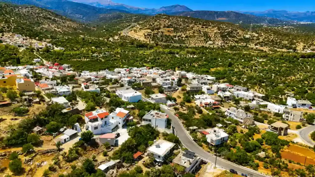 Aerial view of Kalo Chorio village surrounded by olive groves and inland hills
