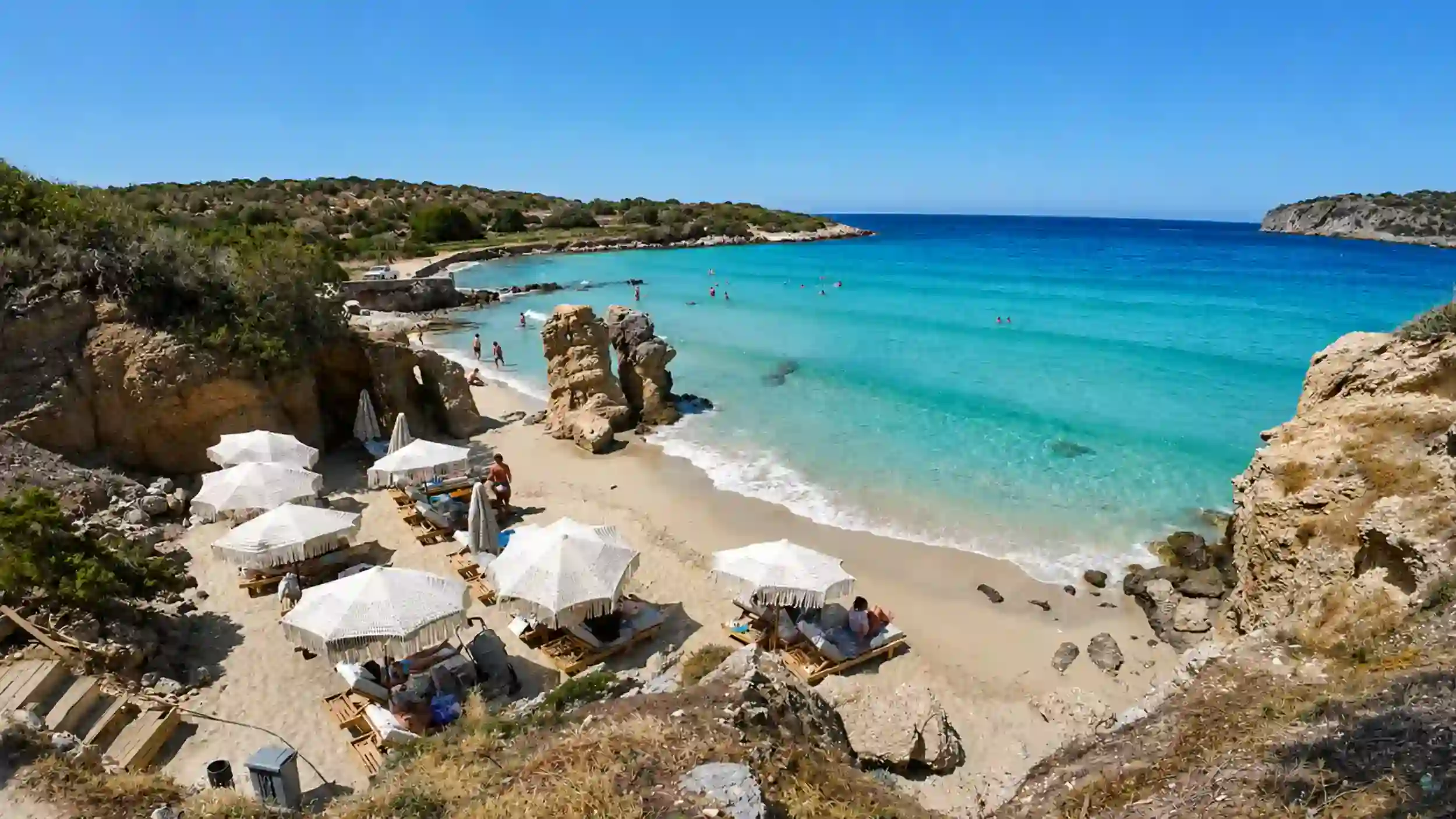Voulisma Beach sunbeds and turquoise cove, one of the beaches near Agios Nikolaos