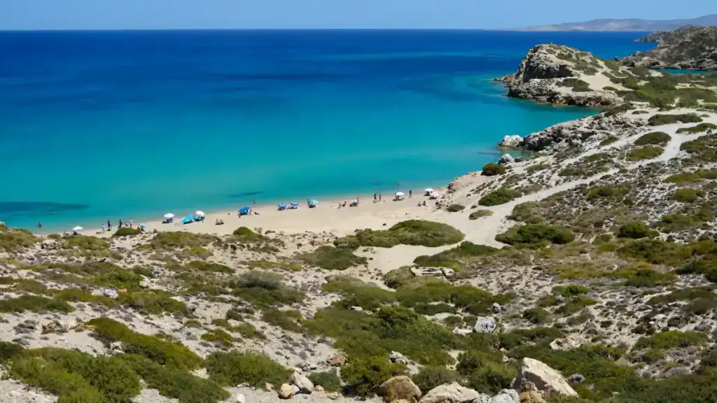Rocky scrubland sloping down to the sandy cove at Itanos, one of the best beaches in East Crete
