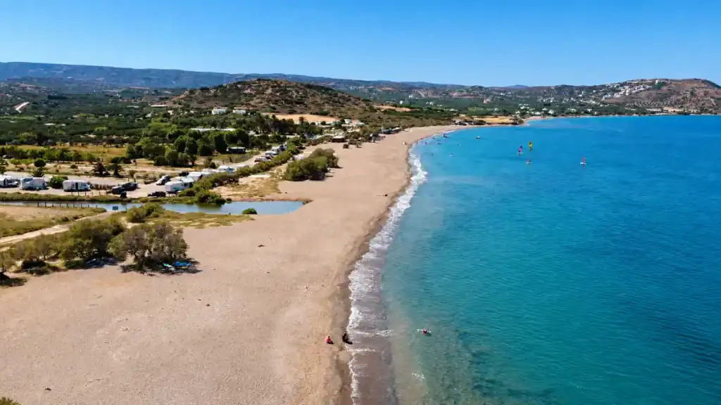 Wide sandy shoreline and turquoise water at Kouremenos Beach in East Crete Travel Guide