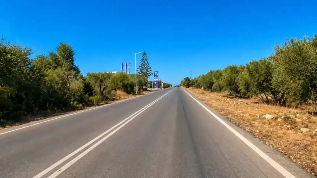 Empty coastal road through olive groves in East Crete Travel Guide near Sitia