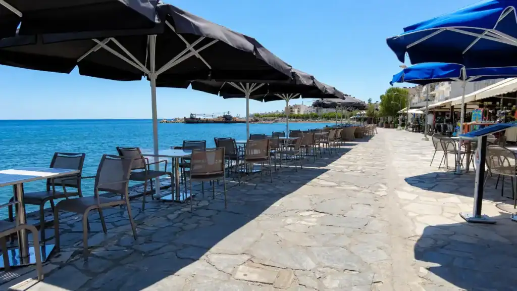 Seafront cafés and shaded terrace seating along the promenade in Ierapetra
