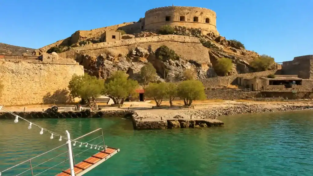 Boat gangway approaching Spinalonga fortress walls when visiting Spinalonga from Elounda