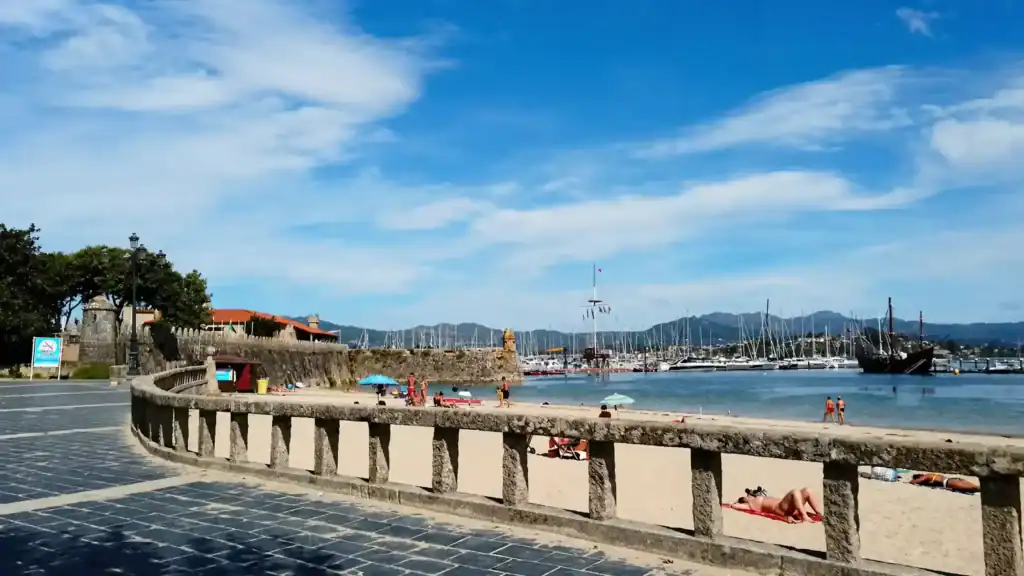 Baiona harbour promenade and beach with sailboats, one of the best days in RĂas Baixas