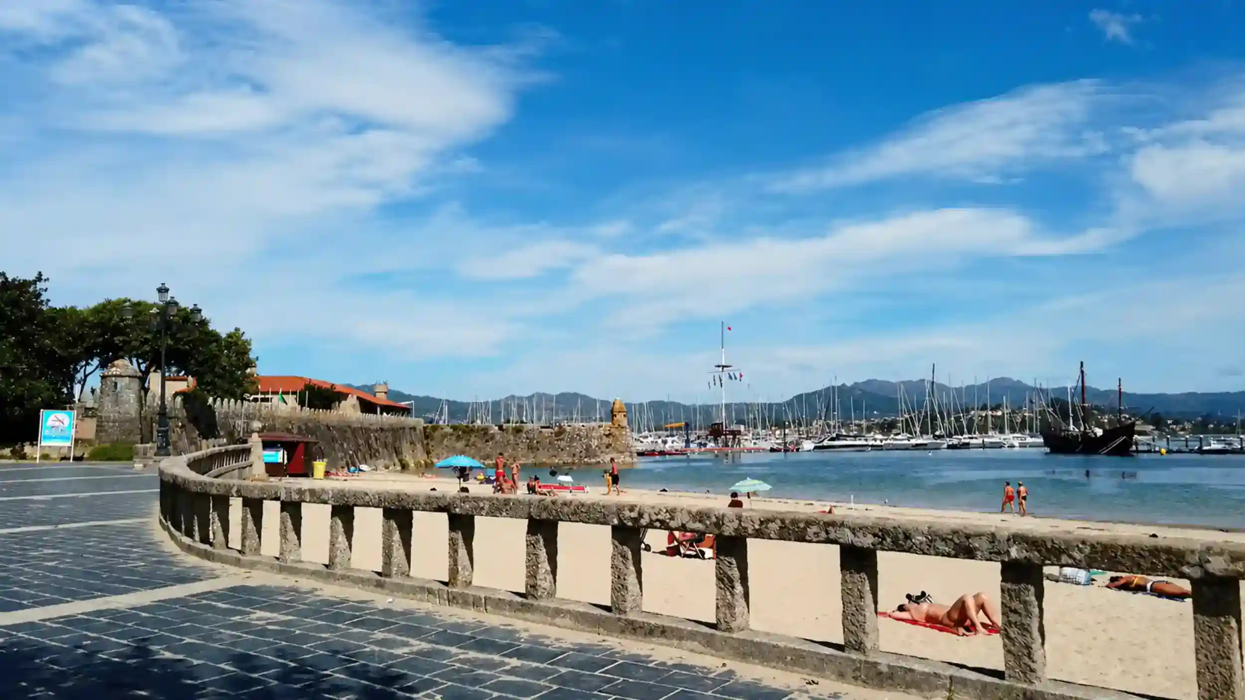 Baiona harbour promenade and beach with sailboats, one of the best days in Rías Baixas