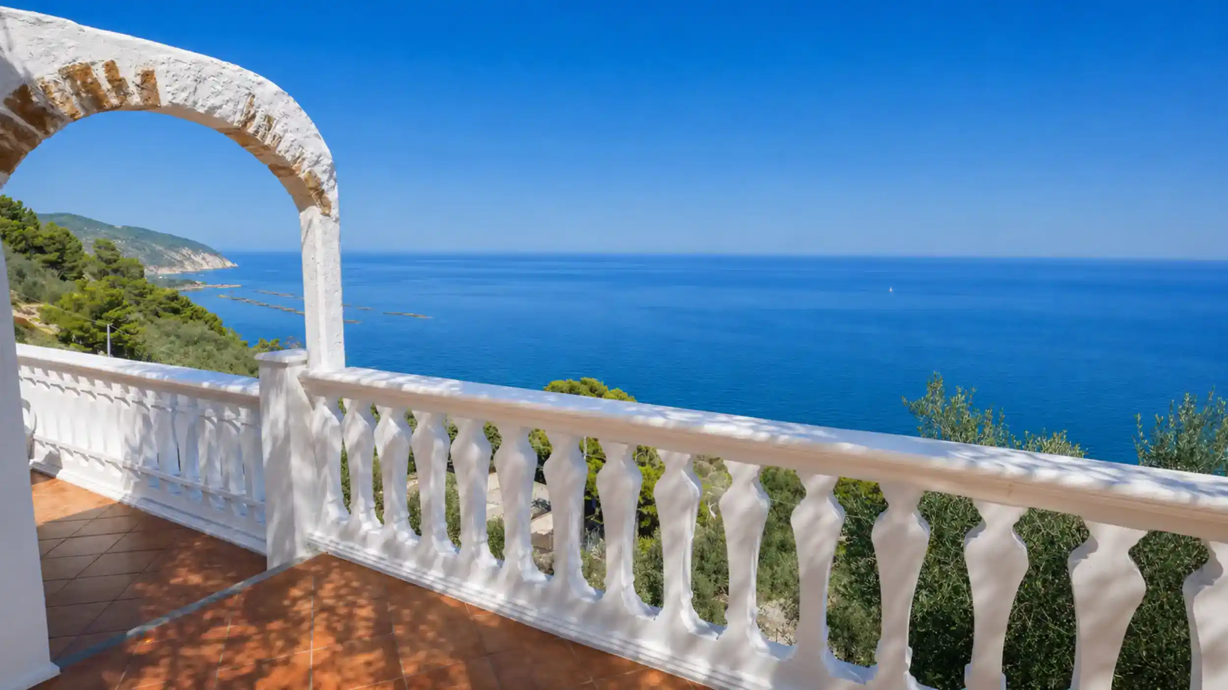Whitewashed terrace arch framing the Adriatic coastline along Gargano Puglia beaches near Mattinata.