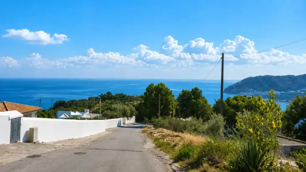Coastal road descending through hillside scrub towards Mattinata on the Adriatic.