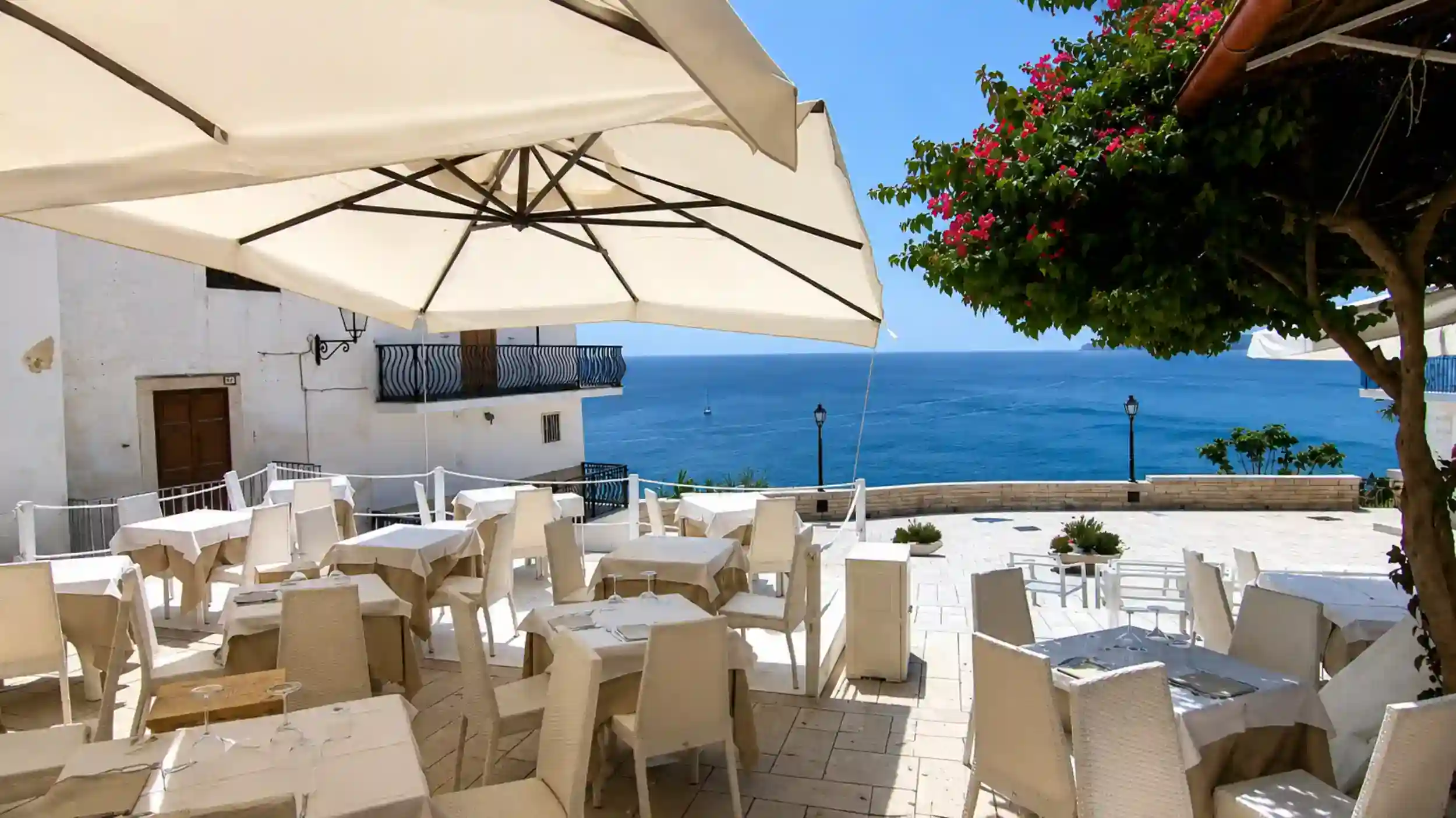 Seafront restaurant terrace at Piazzetta Petrone in Vieste, Gargano Puglia.