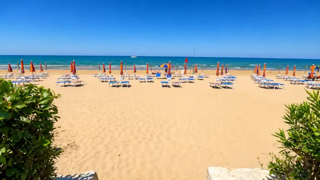 Closed orange parasols on Spiaggia di Mannacora during settled Gargano Puglia weather.
