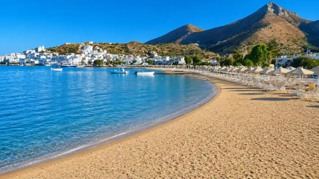 Curved sandy shoreline at Elounda town beach showing why East Crete is worth visiting.