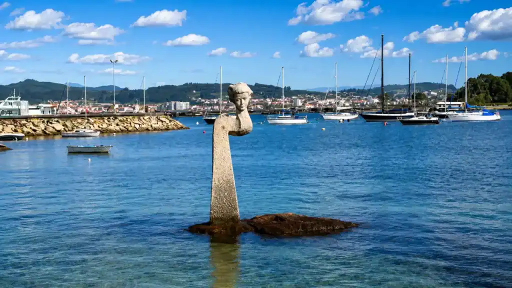 Maruxa dos Portos granite statue rising from the water in O Grove and La Toja marina, Galicia