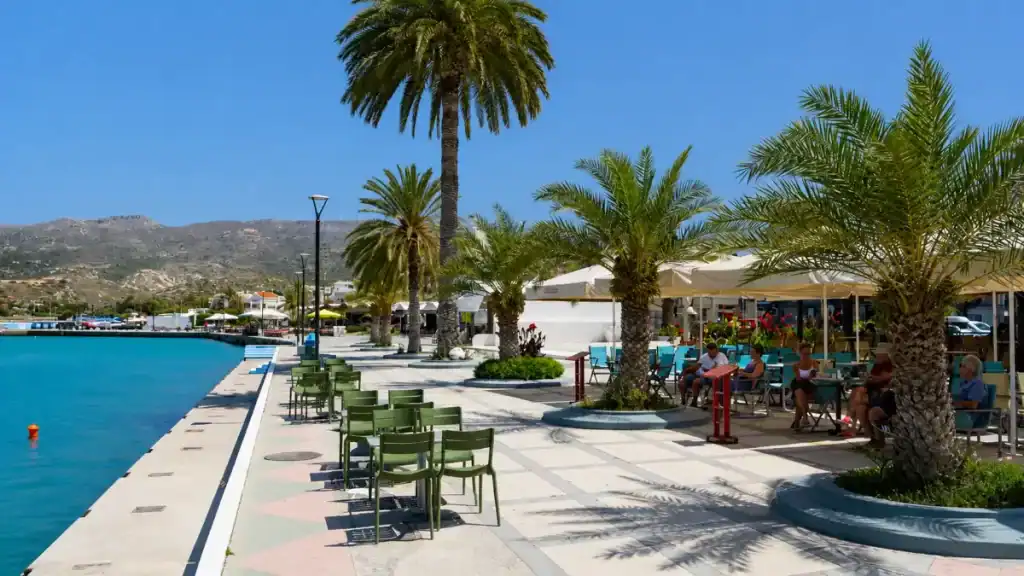 Palm-lined harbour promenade with waterfront cafés in Sitia and Palekastro area of eastern Crete