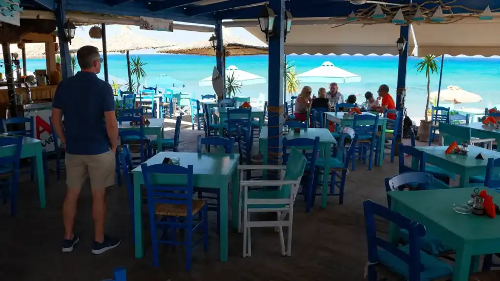 Blue and turquoise taverna chairs facing the bay at Kato Zakros beachfront