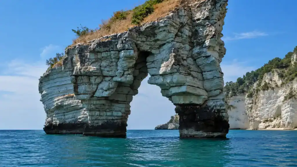 Limestone sea arch off the Gargano coast, departure point for a Tremiti Islands day trip.