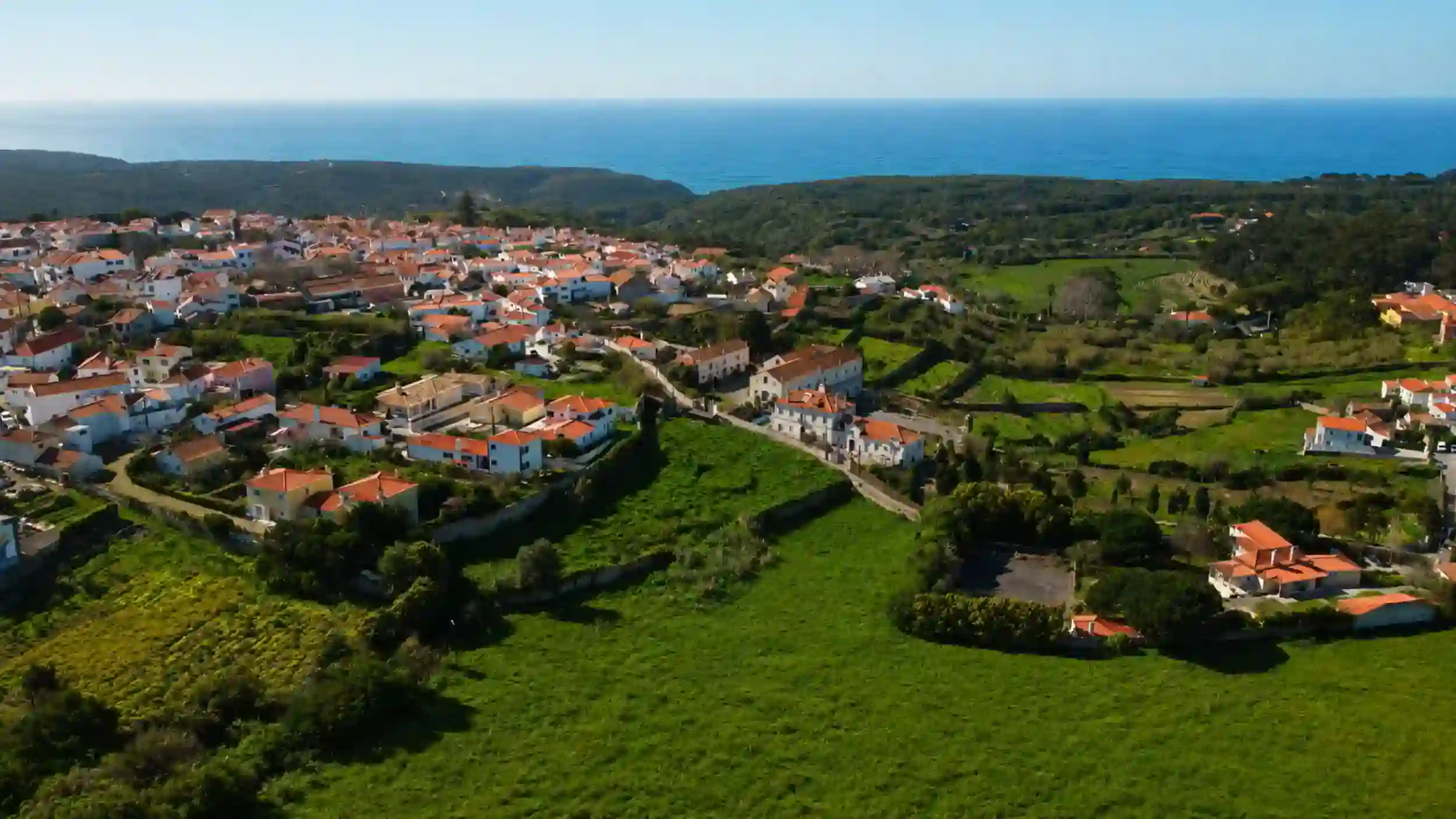 Whitewashed rooftops of Almoçageme spread across the hillside above the Atlantic.