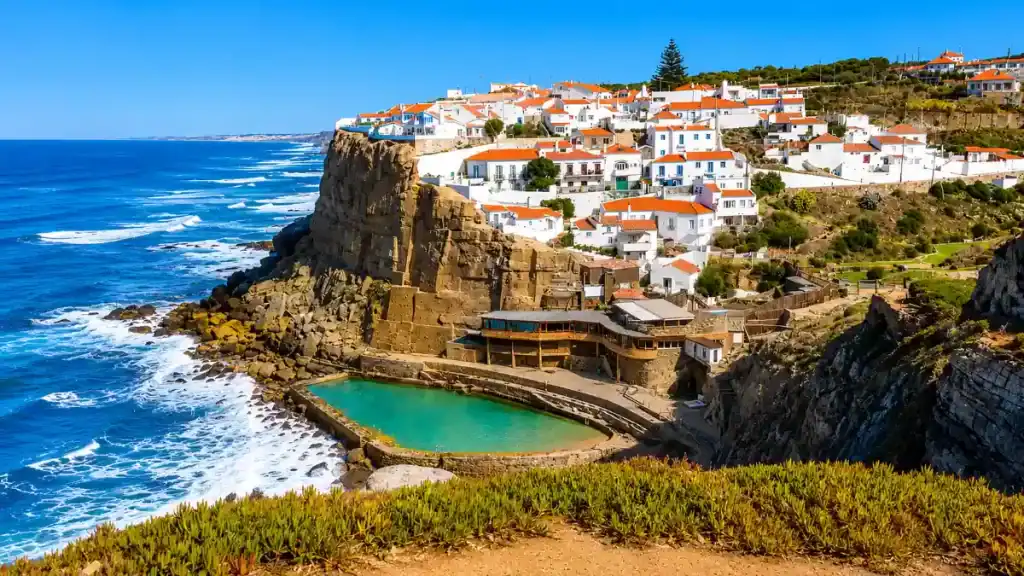 Azenhas do Mar whitewashed village and natural rock pool perched above Atlantic cliffs